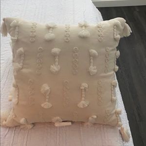 Cream colored throw pillow